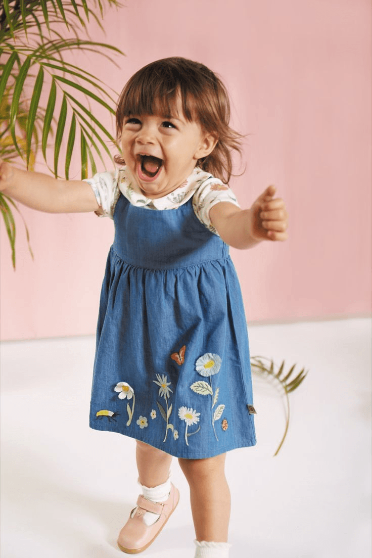 Child in blue embroidered dress